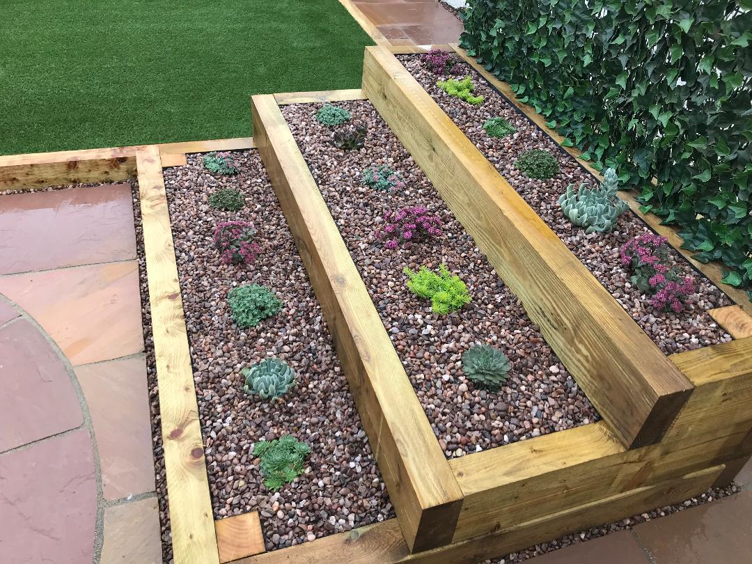 We can build raised planters from railway sleepers, block and render or brick. There is no limitation on shape or design. The picture above shows our take on a modern rockery.